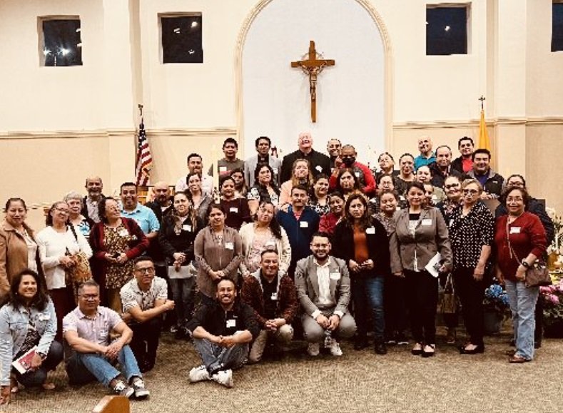 Members of the Hispanic/Latino community of the Indianapolis West Deanery pose for a photo with Father John McCaslin, pastor of St. Monica's in Indianapolis, and Felix Navarrete, Hispanic ministry coordinator for the Archdiocese, (in the front row immediately below the crucifix), during a National Eucharistic Revival meeting held April 18 at St. Ann Church in Indianapolis. (OSV News/handout photo via The Criterion)