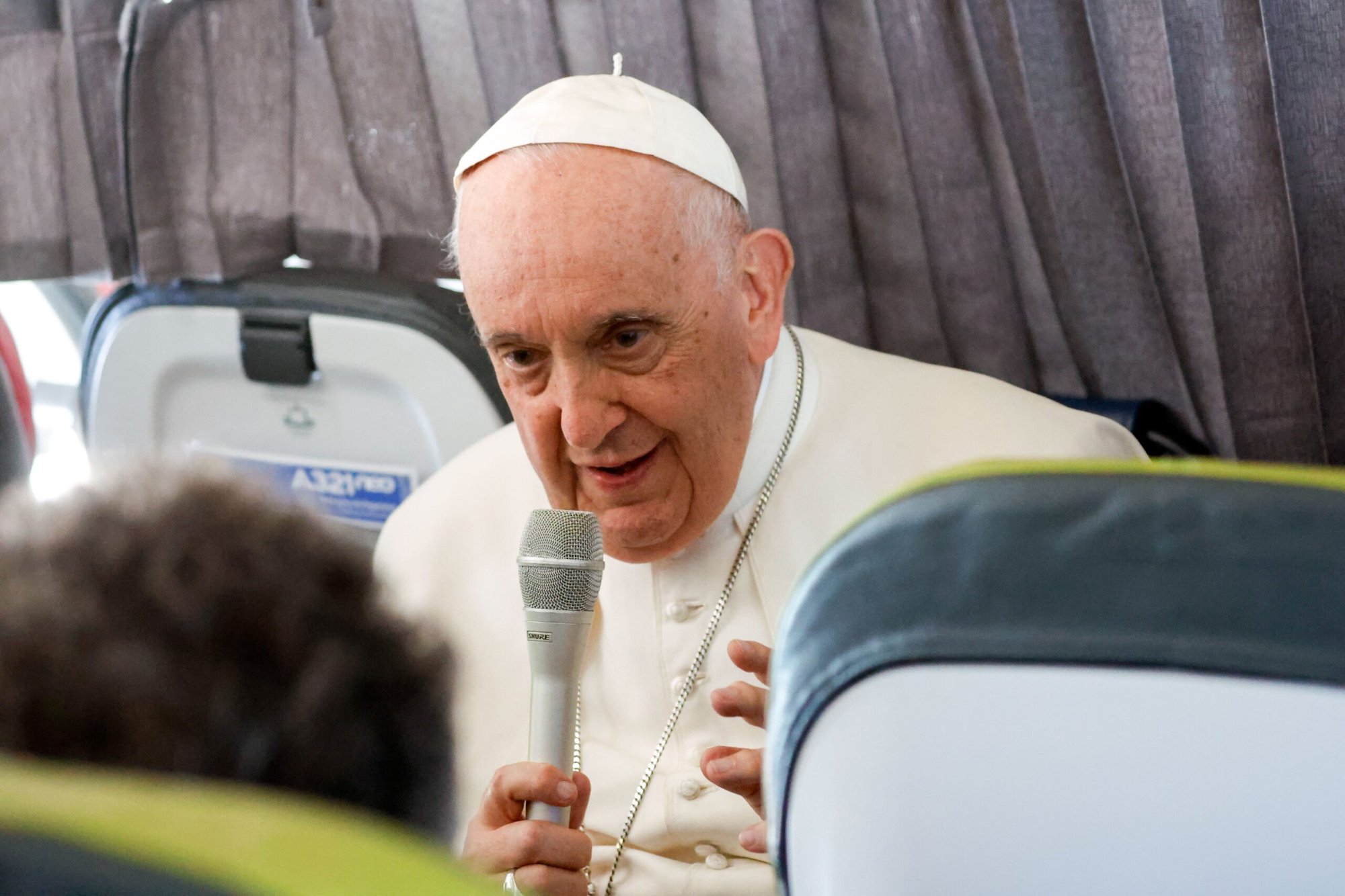 Pope Francis answers questions from journalists aboard his flight back to Rome from Lisbon, Portugal, Aug. 6, 2023, after his participation in World Youth Day. (CNS photo/Lola Gomez)