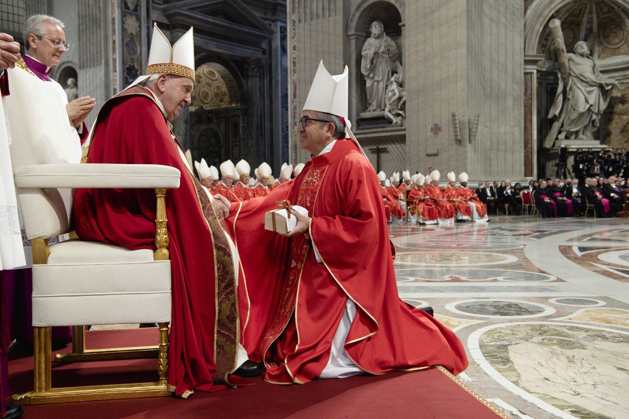 El Papa Francisco estrecha la mano del arzobispo de Valladolid, Luis Javier Argüello García, después de entregarle una caja que contiene un palio, una estola de lana que se lleva alrededor de los hombros, al final de una misa en la Basílica de San Pedro en el Vaticano el 29 de junio de 2022, fiesta de San Pedro y San Pablo. (CNS photo/Vatican Media)