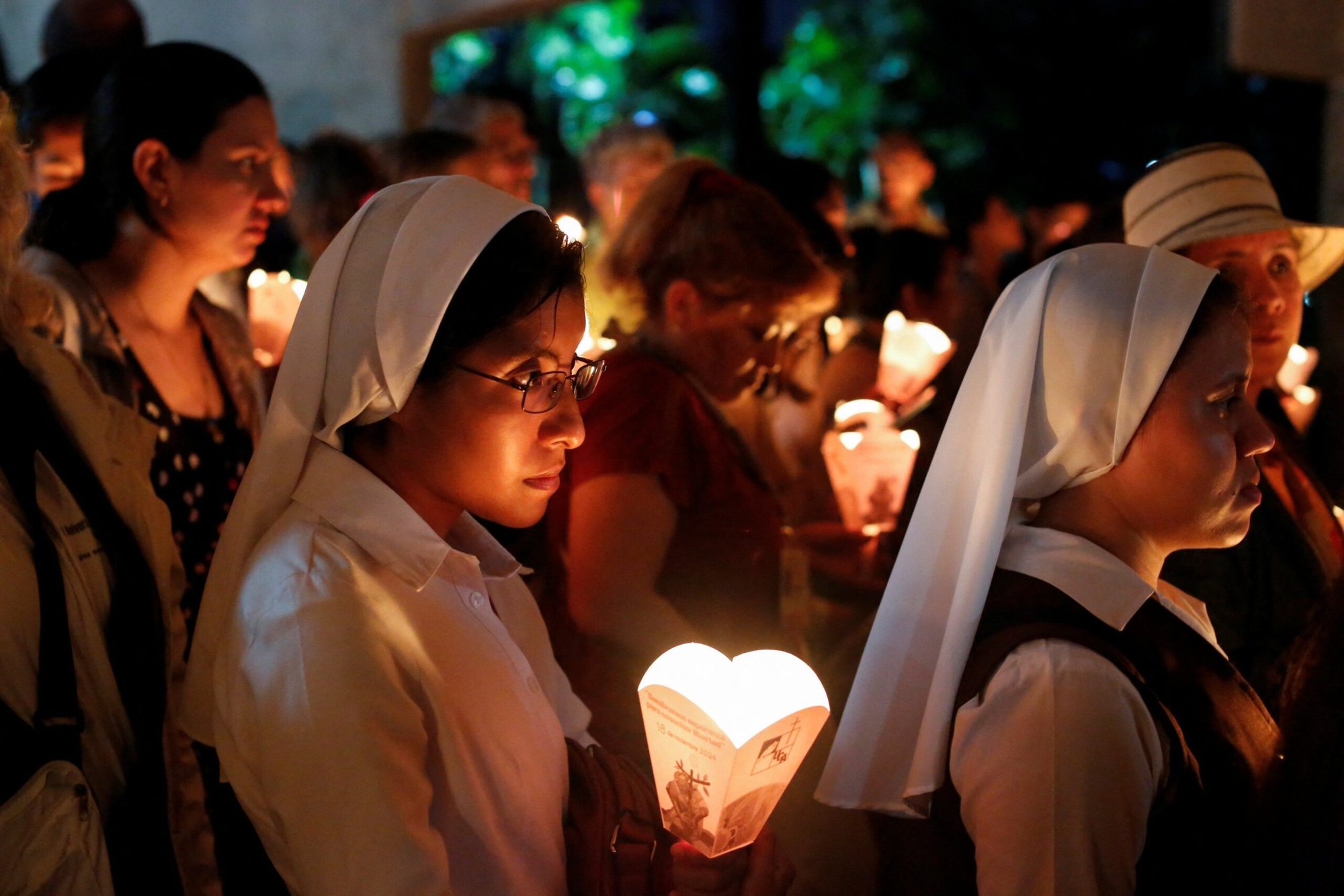 Salvadoreños participan en la tradicional procesión de las luces el 16 de noviembre de 2024, en la Universidad Centroamericana de San Salvador, durante la conmemoración del 35 aniversario de los mártires jesuitas. En 1989, seis jesuitas, su ama de llaves y su hija fueron asesinados en el campus de la Universidad Centroamericana. (Foto OSV News/Jose Cabezas, Reuters)
