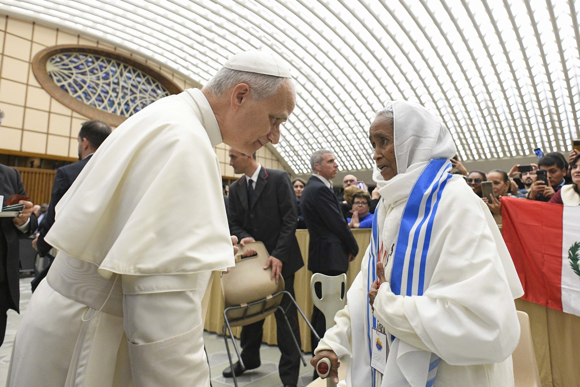 El Papa León XIV saluda a una mujer durante una reunión de movimientos populares o movimientos sociales como parte de su Jubileo en la Sala de Audiencias Pablo VI del Vaticano, el 23 de octubre de 2025. (Foto CNS/Vatican Media)