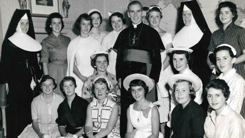 Archbishop Fulton J. Sheen is seen in an undated photo posing with women who worked at the Society for the Propagation of the Faith in New York City. (OSV News photo/Pontifical Mission Societies USA Archives)