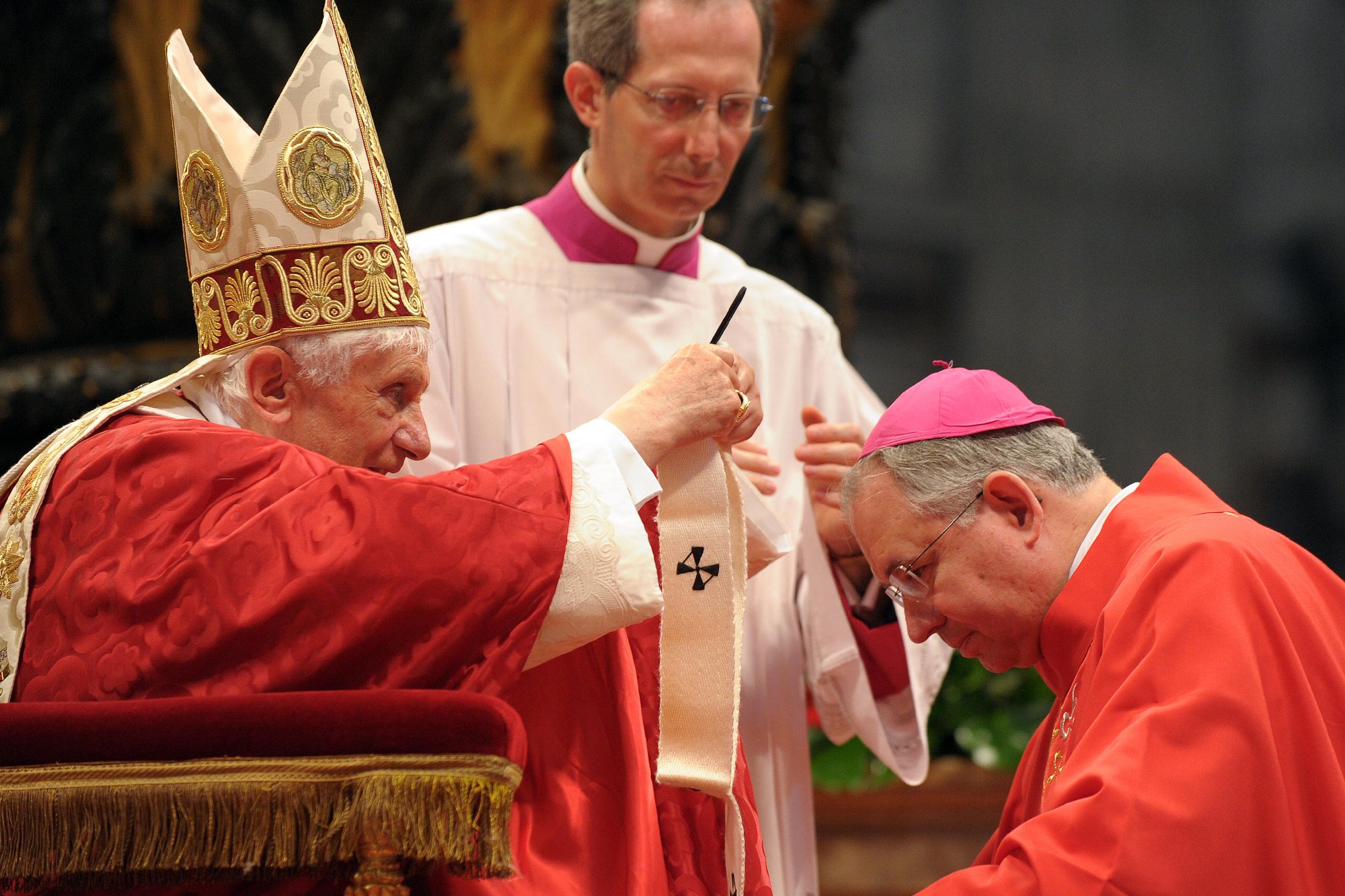 Pope Benedict XVI presents a pallium to Archbishop Jose H. Gomez of Los Angeles in St. Peter's Basilica at the Vatican June 29. During Mass the pope gave 41 archbishops the woolen pallium as a sign of their communion with him and their pastoral responsibility as shepherds. (CNS photo/L'Osservatore Romano)