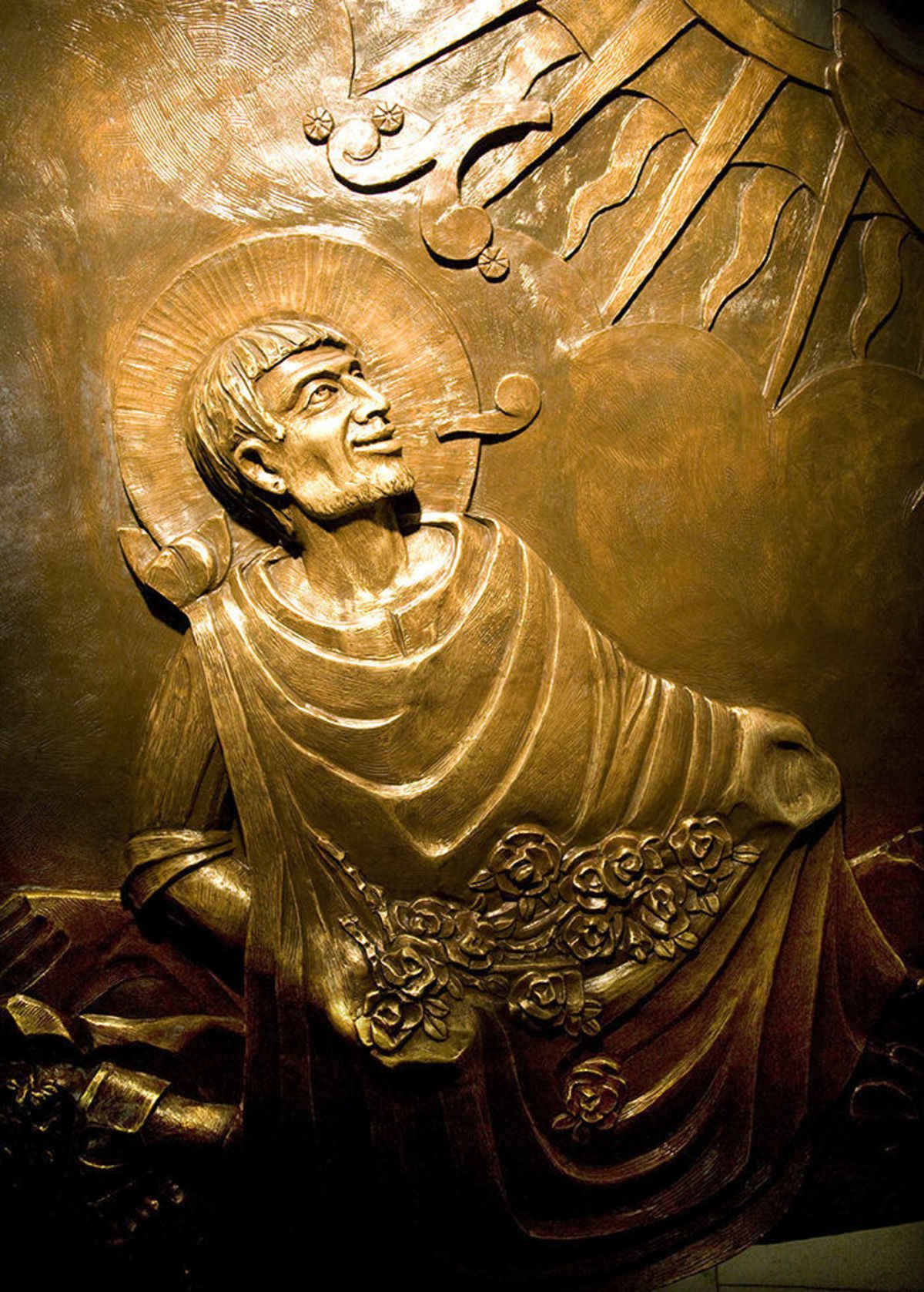 A bronze relief from the Guadalupe Shrine in Mexico City depicting St. Juan Diego kneeling before Our Lady of Guadalupe. (shutterstock.com)