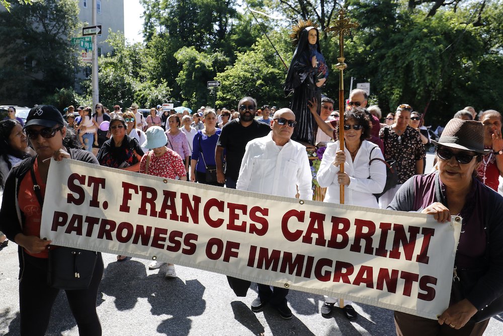 People participate in a procession for immigrant rights July 13