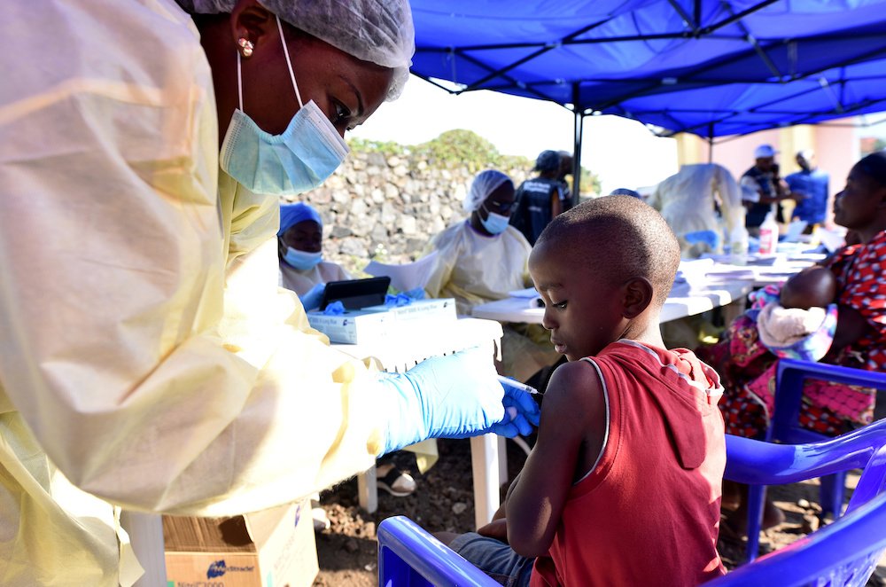 A Congolese health worker administers the Ebola vaccine to a child at the Himbi Health Center in Goma