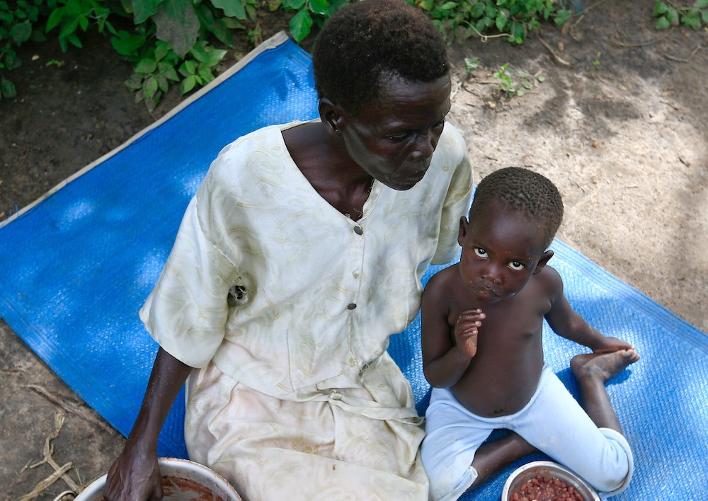 A refugee family from South Sudan eats a meal Nov. 8