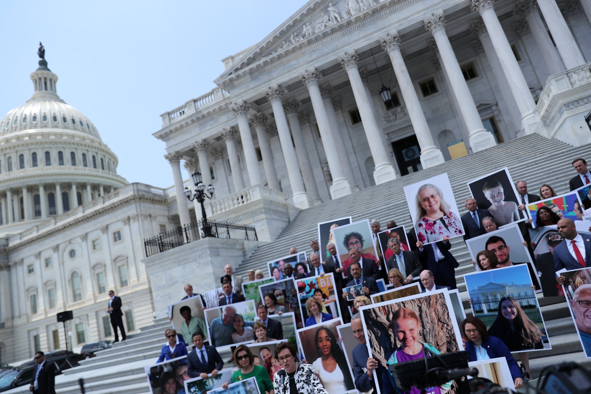Congressional Democrats stand outside the U.S. Capitol July 9