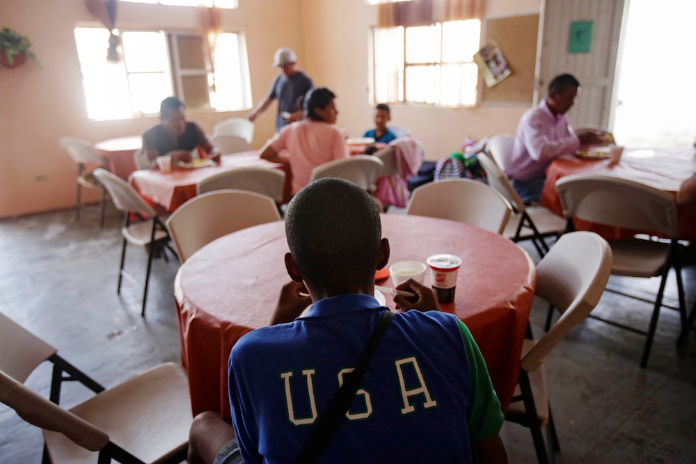 Migrants enjoy a meal inside a shelter in Ciudad Juarez