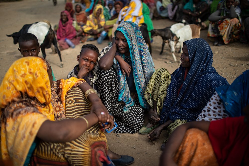 People wait outside a distribution center in Ethiopia's Oromia Region Feb. 9