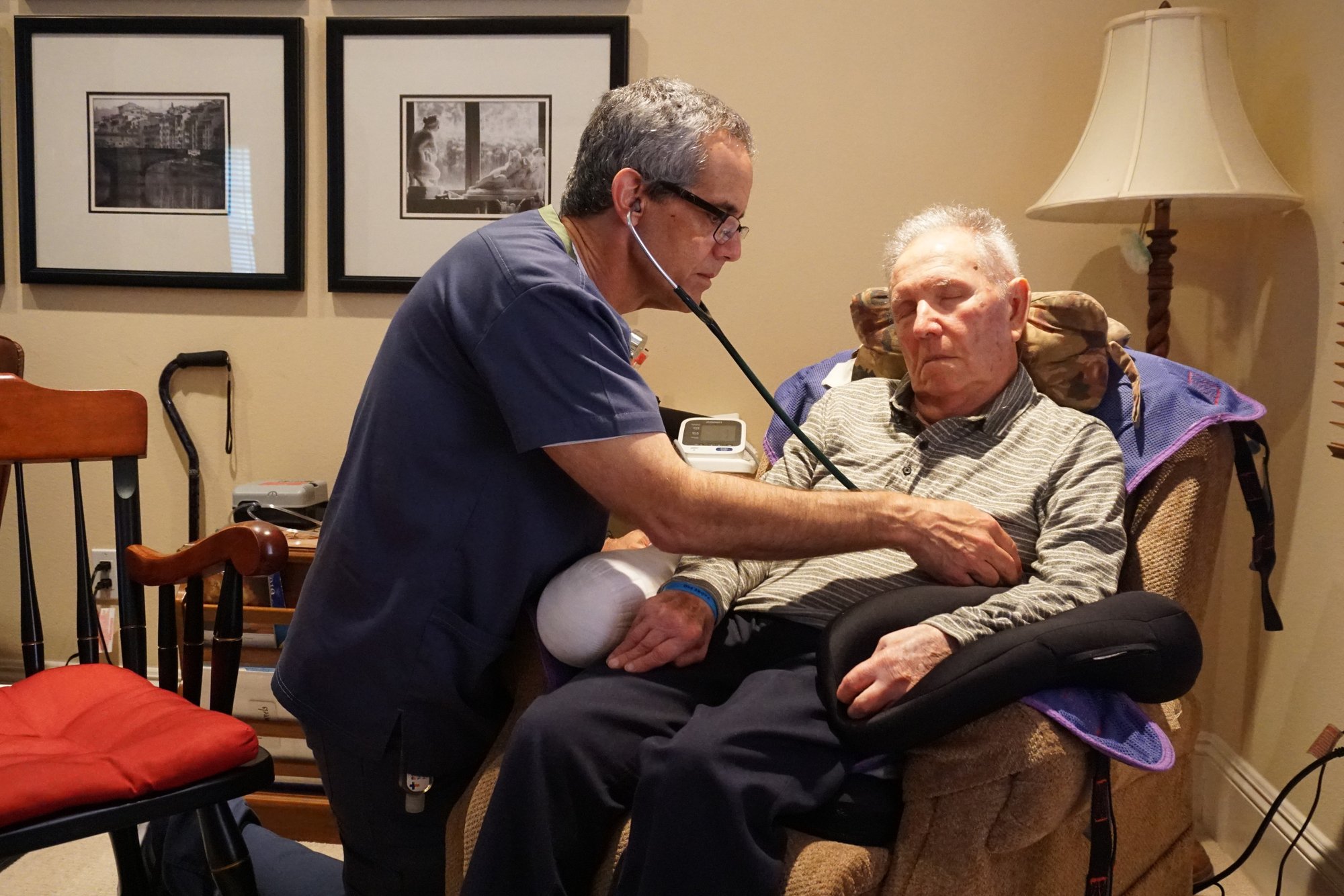 (Above and below) TrinityCare case manager Tom Doyle and a private nurse attend to patient Javier Ricardo Uribe during a recent visit to his Calabasas home. (R.W. DELLINGER)