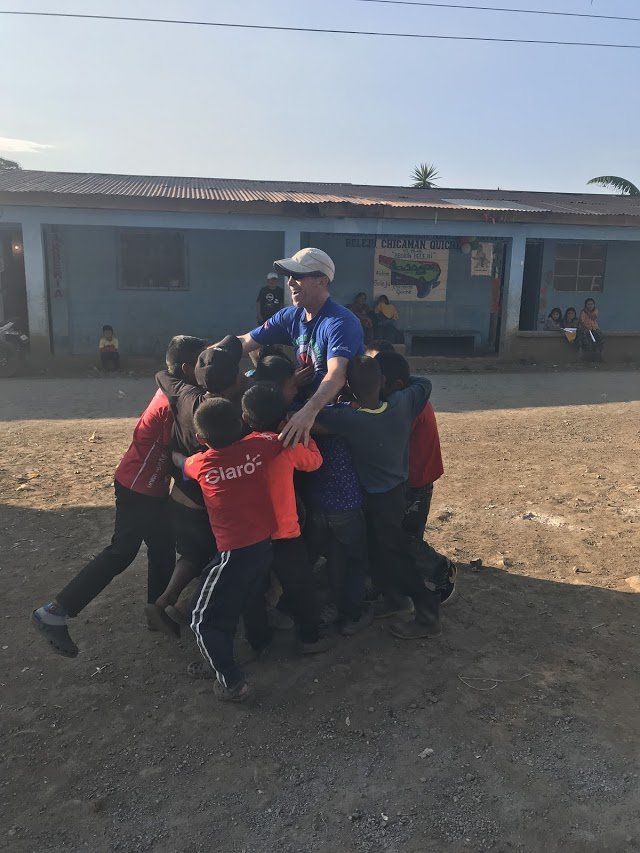 Erik Wexler shares a group hug with several of the children he worked with in Guatemala. (PHOTO COURTESY PROVIDENCE ST. JOSEPH HEALTH)