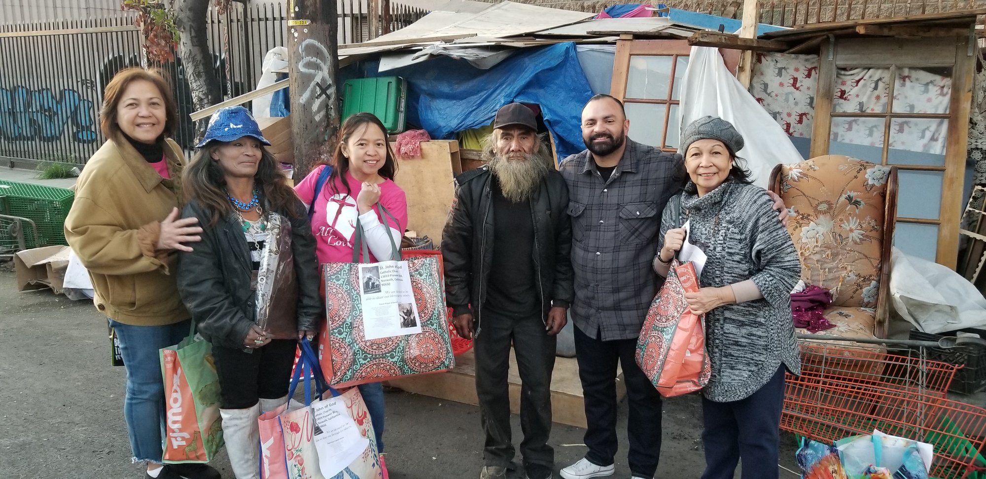 Parishioners from St. John of God hand out Care Bags to the homeless. (PHOTO COURTESY ST. JOHN OF GOD PARISH)