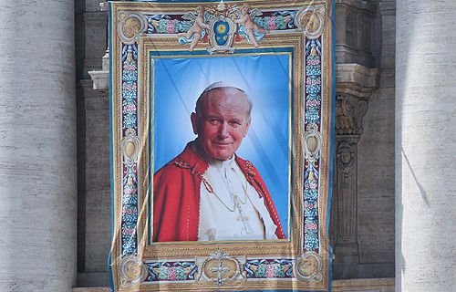 Tapestry of Pope John Paul II hanging from the facade of St. Peter's Basilica at the Vatican April 25