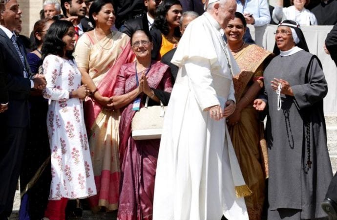 Pope Francis smiles as he walks past pilgrims during his general audience in St. Peter's Square at the Vatican May 8
