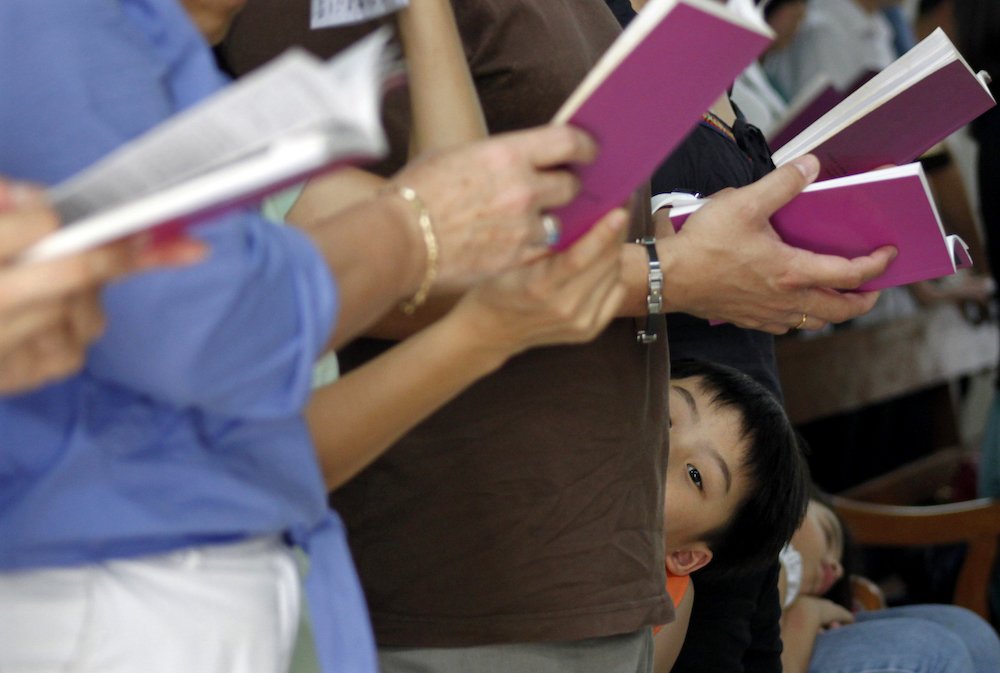 A boy attends Mass with his family at the Church of Sts. Peter and Paul in Singapore April 2