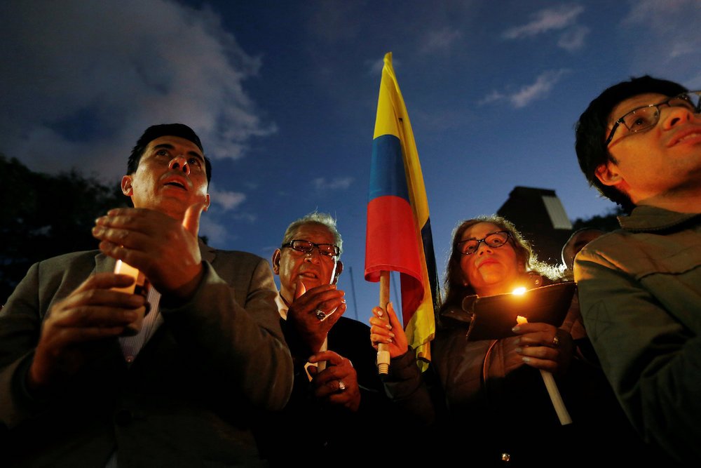 People take part in a candlelight vigil Jan. 18