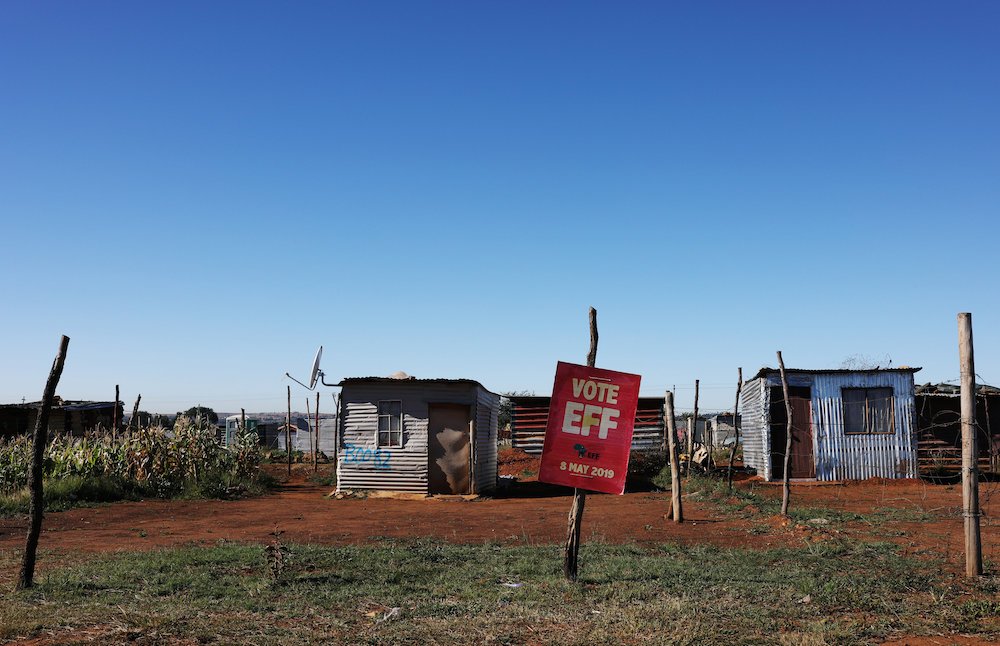 An Economic Freedom Fighters election poster hangs in front of homes outside Johannesburg