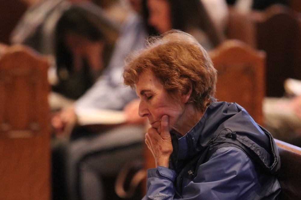 A woman prays during a Mass for victims and survivors if clergy sex abuse at St. Mary Cathedral of the Immaculate Conception in Portland