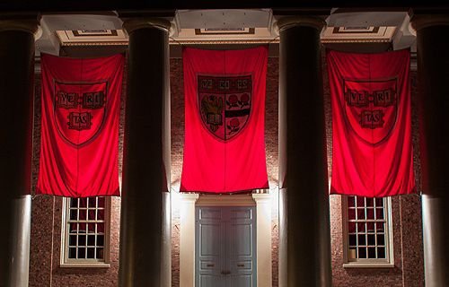 Crimson banners hang outside Memorial Church on the campus of Harvard University in Cambridge
