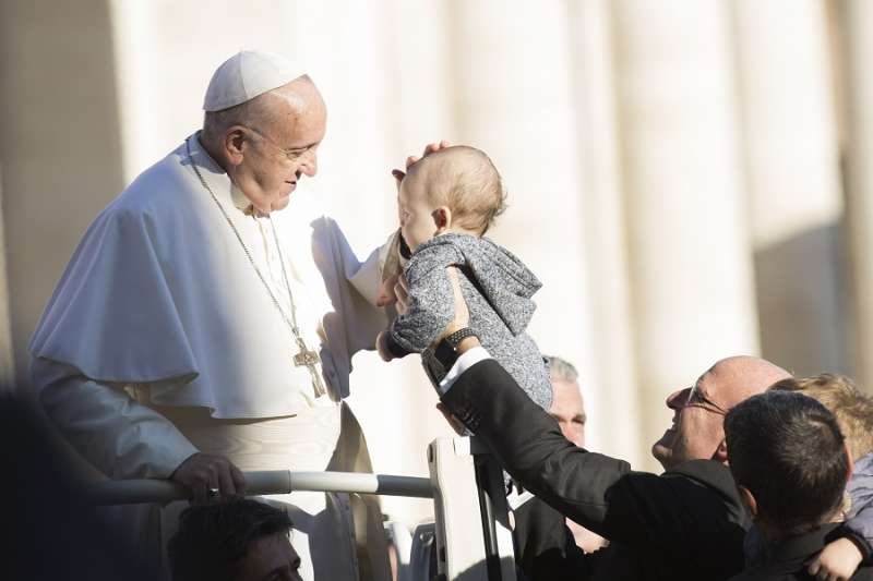 Pope Francis blesses a baby Nov. 21