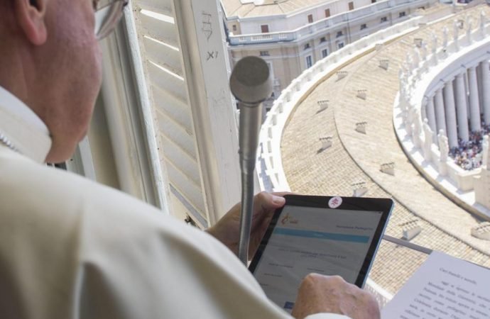 Pope Francis uses his tablet computer to register for the 2016 World Youth Day. (L’Osservatore Romano via Crux)