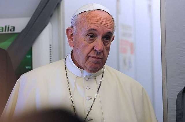 Pope Francis on the papal flight from Rome