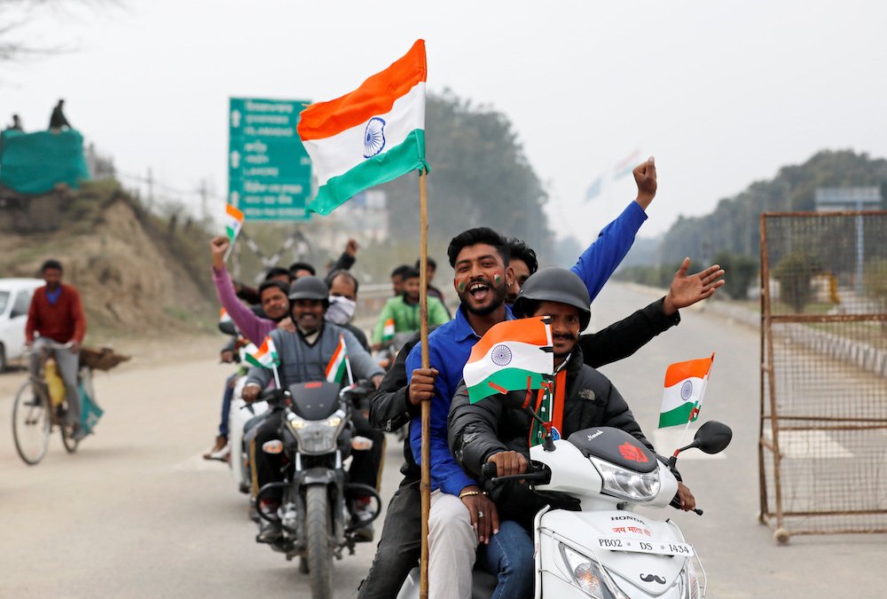 People ride motorbikes on the outskirts of Amritsar