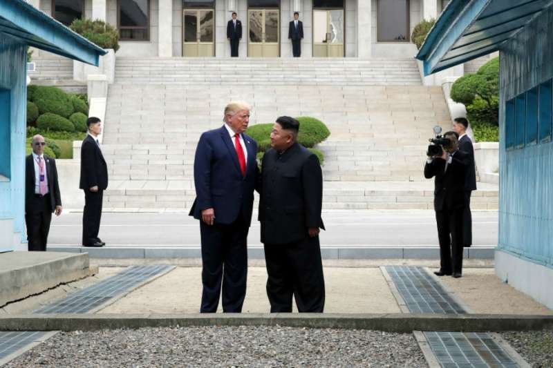 Kim Jong Un and Donald Trump meet at the DMZ separating the South and North Korea on June 30