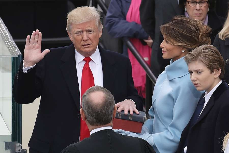 Supreme Court Justice John Roberts (2L) administers the oath of office to U.S. President Donald Trump