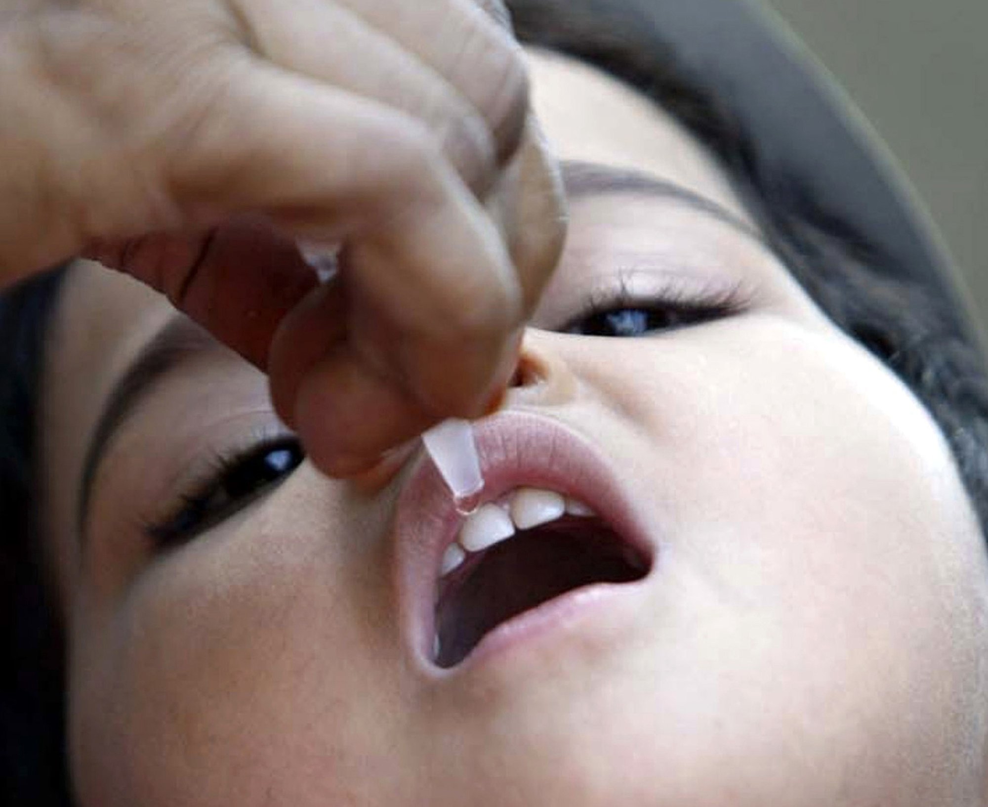 A child is vaccinated with polio drops. Manila Auxiliary Bishop Broderick Pabillo called on Filipinos to have their children vaccinated against the poliovirus immediately after the nation's health officials declared a polio outbreak. (CNS photo/Raj Patidar, Reuters)