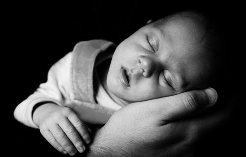 Sleeping Baby On A Hand by Vera Kratochvil (CC0 1.0).