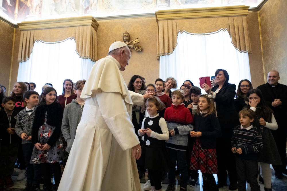 Pope Francis greets a delegation from the children and teens section of Italy's Catholic Action during an audience at the Vatican Dec. 20. (CNS photo/Vatican Media)