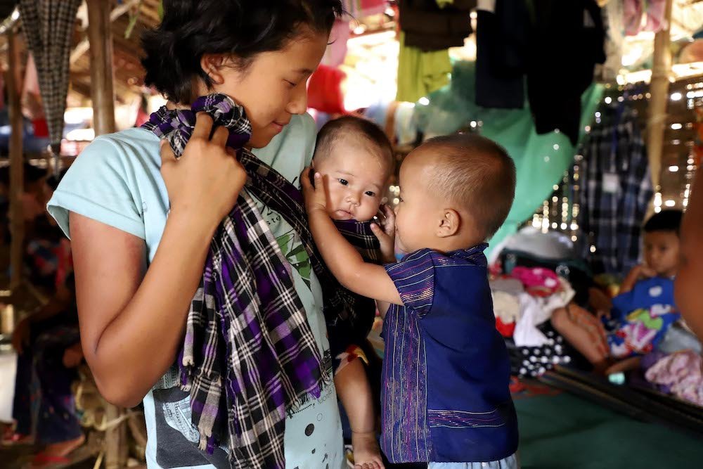 A displaced ethnic Kachin family is seen in early May at a temporary camp on the grounds of a Catholic church in Myitkyina