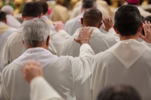 Priests concelebrate with Pope Francis during the Chrism Mass in St. Peter's Basilica March 24