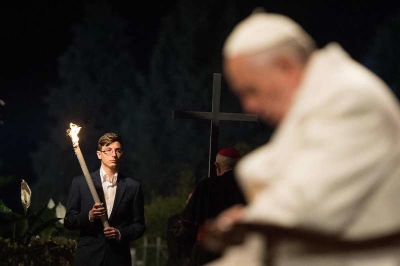 Pope Francis prays during the Stations of the Cross at the Colosseum in Rome
