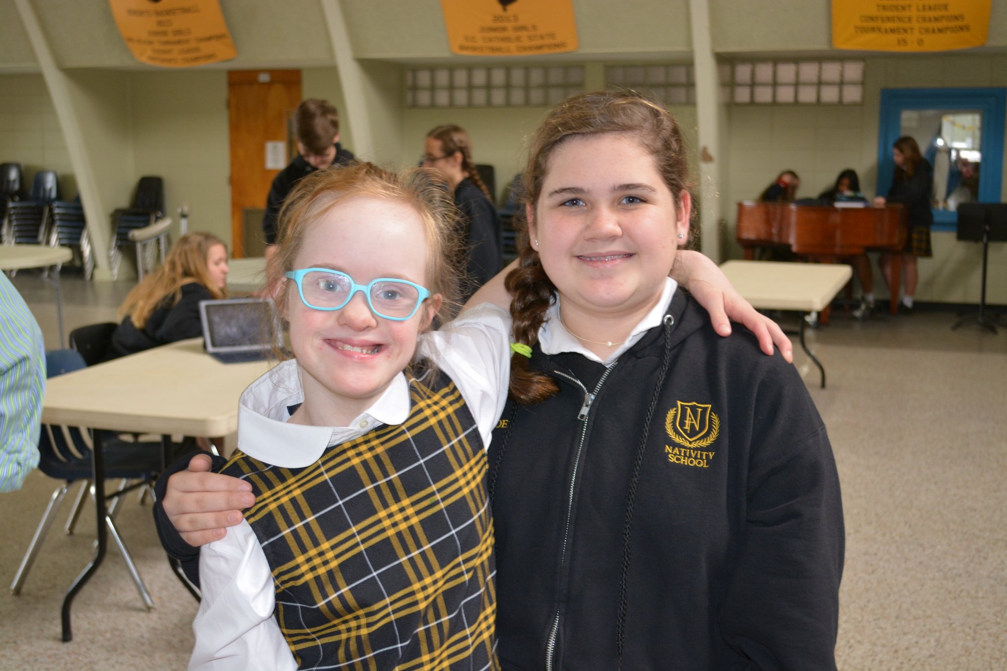 Maybelle May poses with a friend at Nativity School on James Island