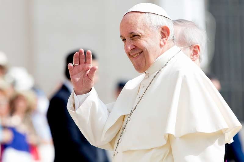 Pope Francis waves to pilgrims during his June 6