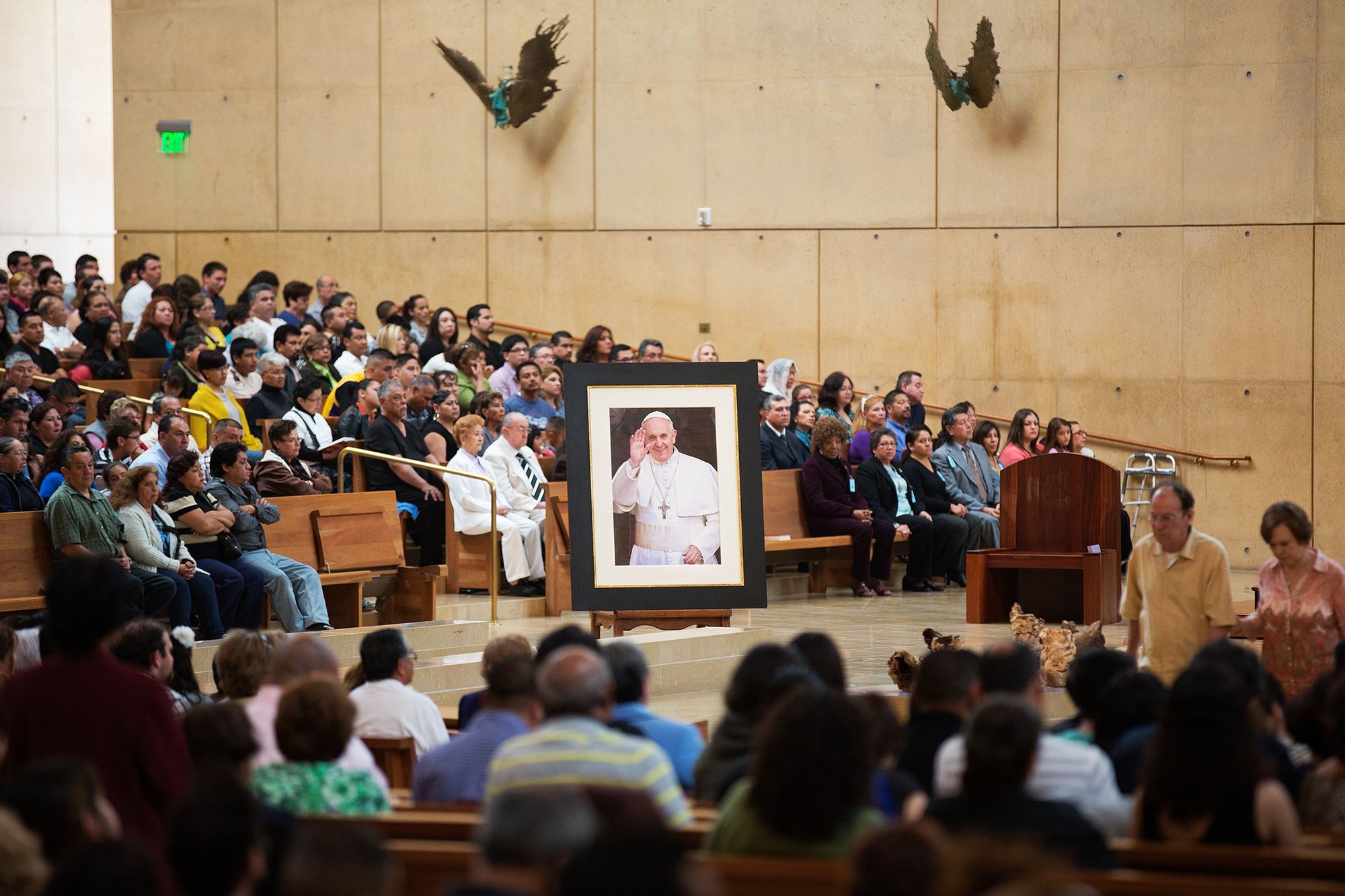 A portrait of Pope Francis is seen surrounded by the congregation during a Sunday Spanish Mass at the Cathedral of Our Lady of the Angels in Los Angeles March 17