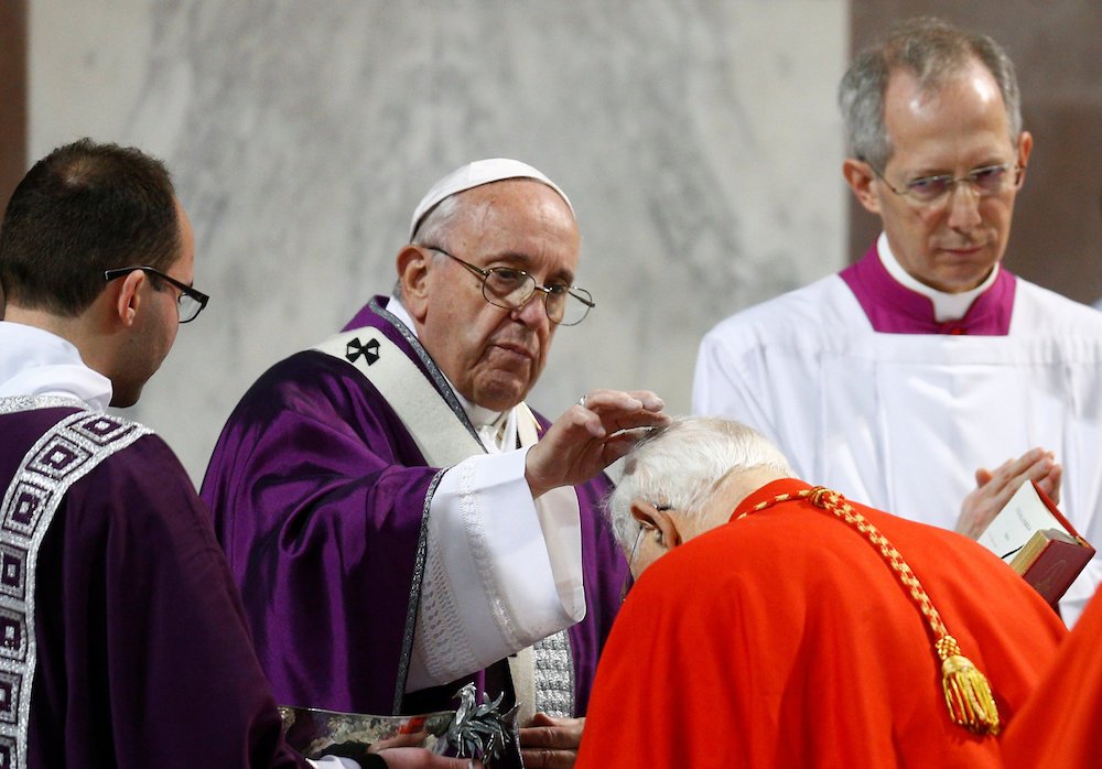 Pope Francis places ashes on the head of a cardinal during Ash Wednesday Mass at Santa Sabina Basilica in Rome March 6