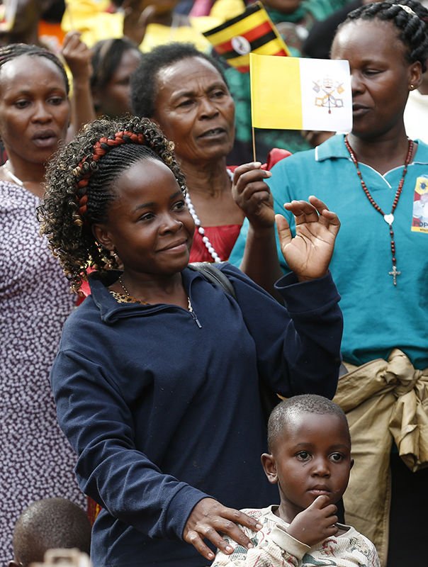 People wait for Pope Francis' arrival to celebrate Mass for the martyrs of Uganda near the Catholic shrine at Namugongo in Kampala