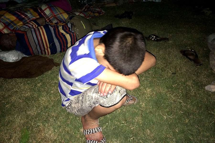 A young refugee rests after having fled from ISIS and arrived in Ankawa in the northern part of Erbil