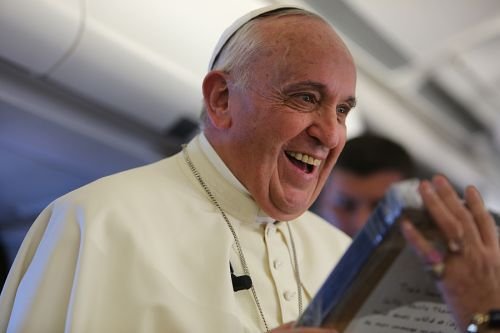 Pope Francis receives a gift of a bas relief of St. Therese of Lisieux from journalist Caroline Pigozzi of Paris Match