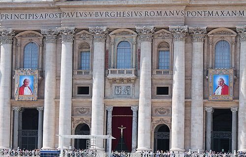 The images of Pope John XXIII and Pope John Paul II hanging from the facade of St. Peter's Basilica at the Vatican April 25