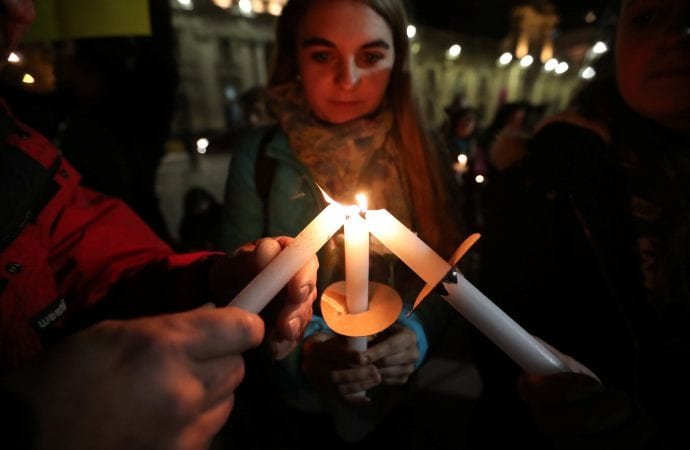 People light candles during an Aug. 20 vigil to protest sexual abuse in the Chilean Catholic Church outside the Santiago cathedral. (Ivan Alvarado?CNS