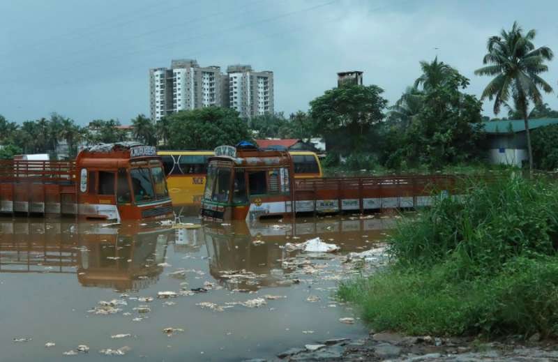 Submerged vehicles on a flooded street are pictured following monsoon rains in Kochi