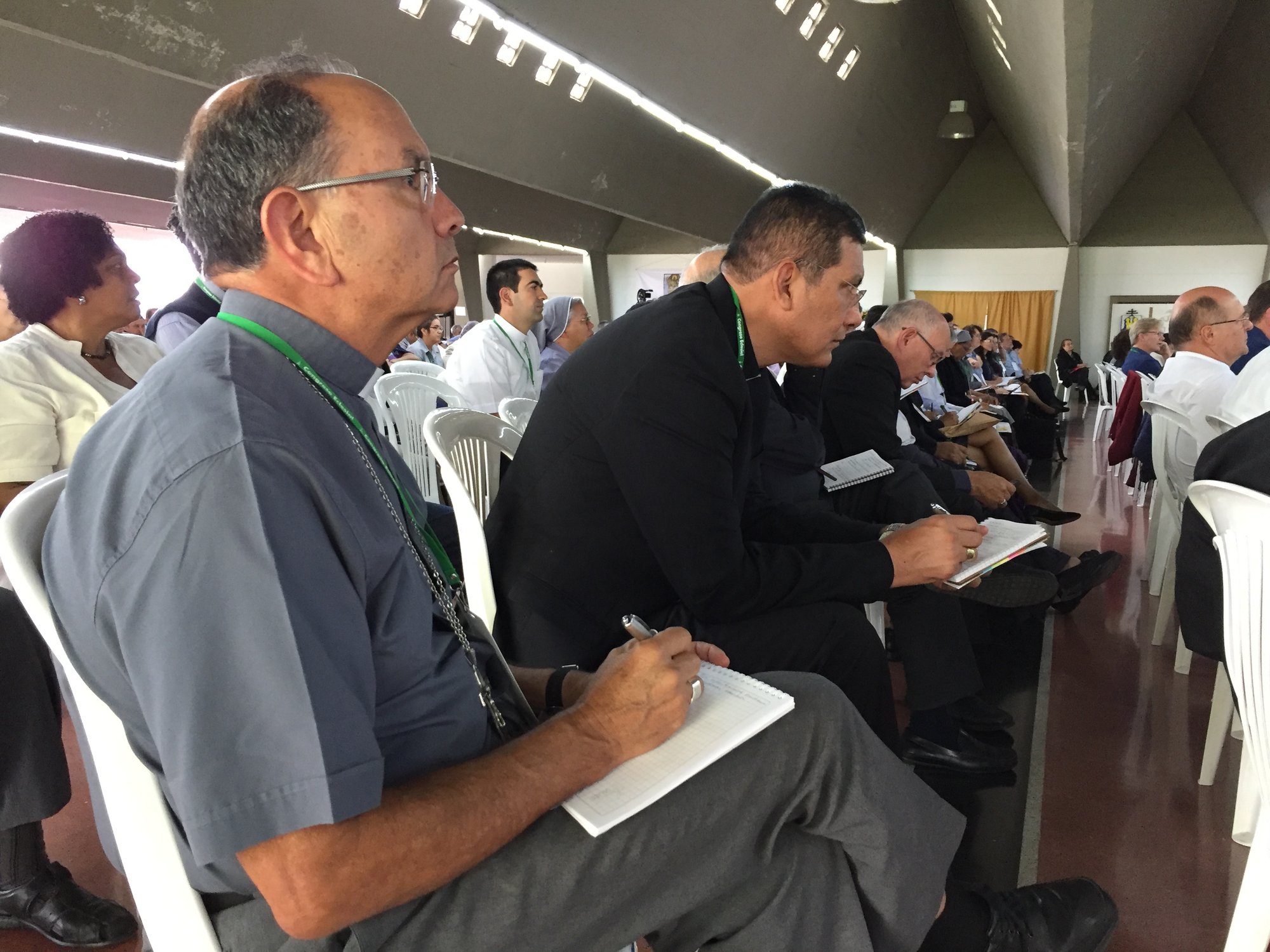 Colombian church leaders take notes during the second day of events Aug. 25 at the commemoration marking 50 years since the historic Medellin bishops’ conference. (CNS photo/Cody Weddle)
