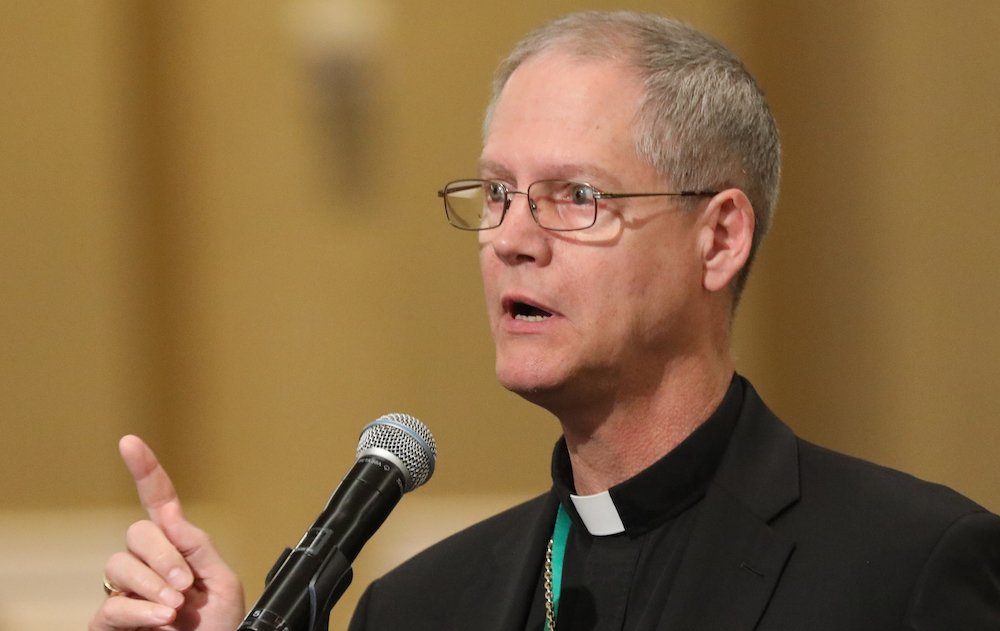 Coadjutor Archbishop Paul D. Etienne of Seattle speaks from the floor during the spring general assembly of the U.S. Conference of Catholic Bishops in Baltimore June 13