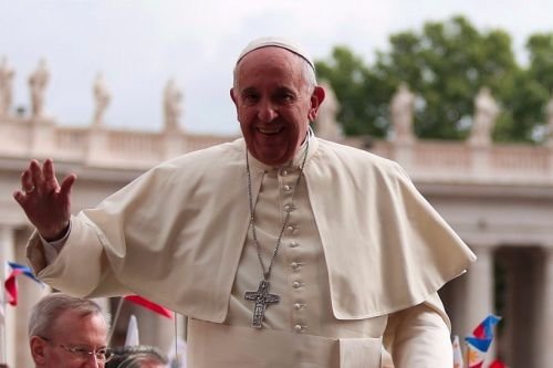 Pope Francis waves to pilgrims during his April 27