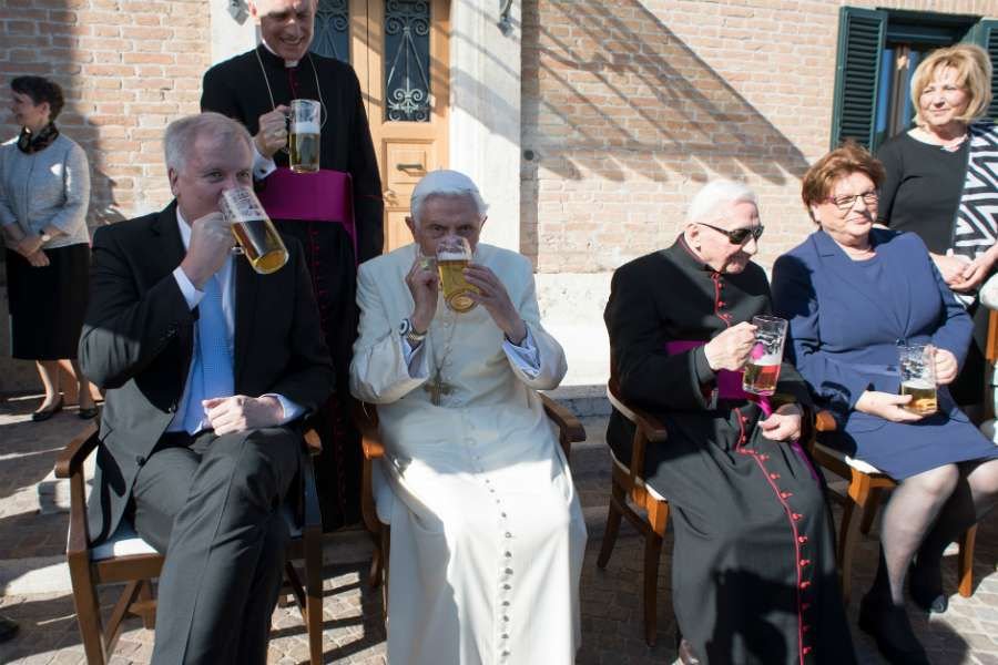 Benedict XVI enjoys a beer at his 90th birthday party at the Vatican's Mater Ecclesiae Monastery